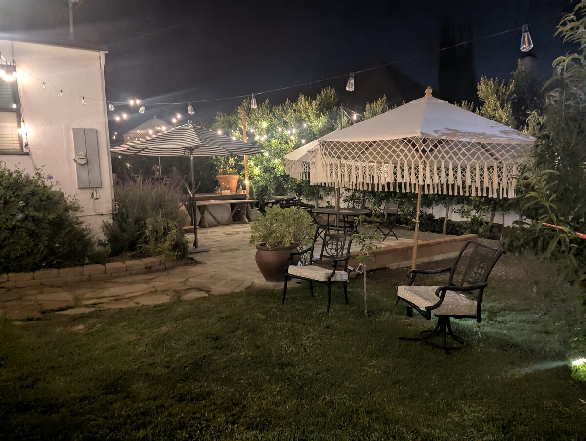 Flagstone courtyard seating under a macrame umbrella